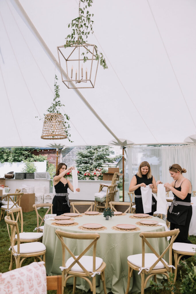 3 wedding planners from The Perfect Match NH folding linen napkins for a tented wedding